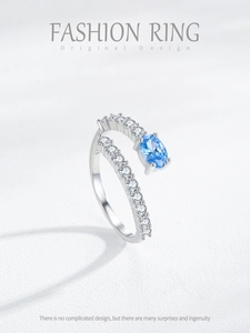 Macro shot of S925 sterling silver mermaid tear ring with blue gemstone and side diamonds