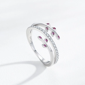 Creative S925 sterling silver leaf ring with sparkling crystals on white textile background