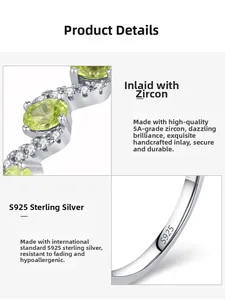 Macro shot of S925 sterling silver stamp and sparkling green zircon inlay on wave ring