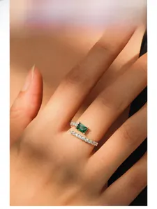Detailed model shot of an adjustable S925 silver ring featuring emerald-cut green gemstone