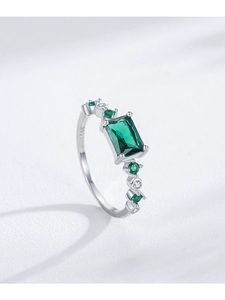 Close-up of S925 silver ring featuring an emerald-cut green stone and side diamonds