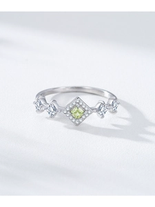 Macro detail of S925 silver ring featuring a square apple green zircon in crown setting