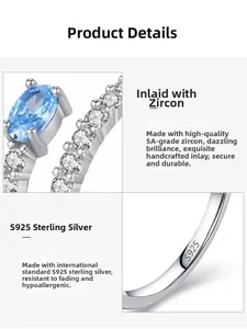 Detailed macro view showing the S925 sterling silver hallmark and blue zircon on the ring
