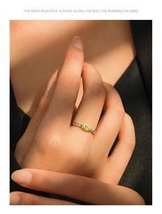 Close-up of S925 silver leaf ring with olive green marquise gemstone on finger