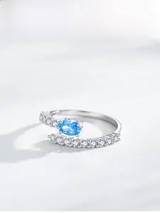 Detailed macro view of S925 sterling silver mermaid tear ring with blue gemstone