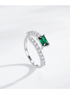 Close-up of S925 silver ring featuring emerald cut green stone and pave set zircons