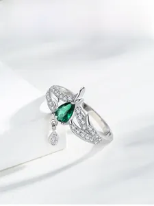 Close-up of S925 silver crown ring with pear-shaped green stone and teardrop pendant
