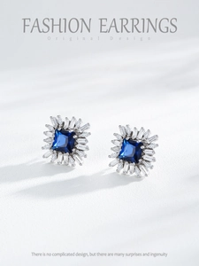 Macro view of S925 sterling silver square blue sapphire earrings with halo diamond petals