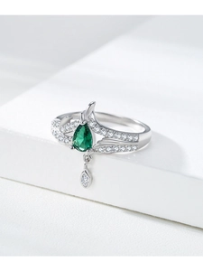 Macro view of S925 silver ring featuring a pear-cut green gemstone and dangling teardrop detail