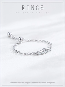 Macro shot of 925 sterling silver chain ring with five sparkling cubic zirconia stones