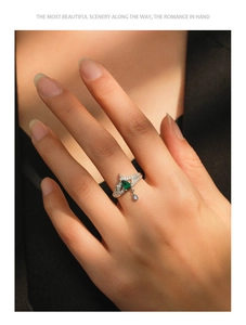 Detailed view of S925 silver ring with pear-shaped green gemstone and crown design