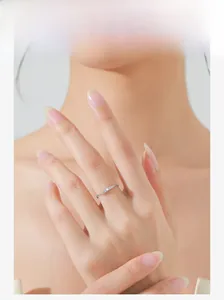 Close-up of a 925 sterling silver wave ring with pavé diamonds on a model's finger