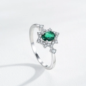 S925 sterling silver oval emerald ring with sparkling zircon halo on white background