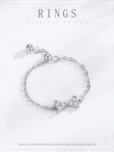 Macro detail of adjustable 925 sterling silver bow knot chain ring with pavé zircons