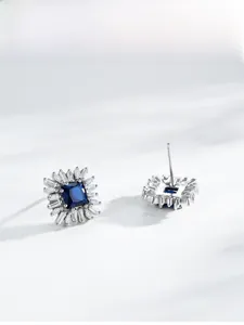 Macro detail of S925 sterling silver square blue halo stud earrings with micro pavé diamonds