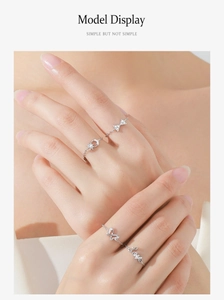 Close-up of 925 sterling silver chain rings with sparkling star, moon and butterfly charms