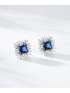 Detailed macro view of S925 silver stud earrings with blue square gems and halo diamonds