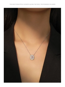 Detail of S925 silver necklace with pink rectangular zircon in a sunburst pendant