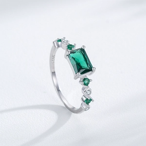 Vintage S925 silver ring featuring a rectangular emerald gemstone with halo accents