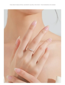Detailed view of sterling silver wave ring with micro-set zircon stones on hand