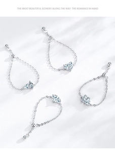 Macro detail of S925 sterling silver chain rings with heart-shaped zircon and adjusters