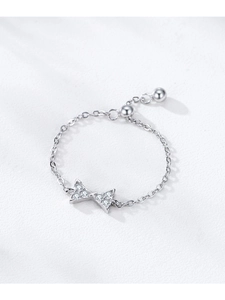Detail of adjustable 925 sterling silver chain ring with pavé zircon bow and slider bead