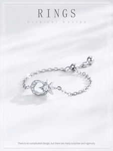 Detailed macro view of S925 sterling silver star and moon chain ring with pavé zircons