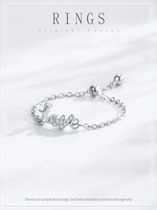 Detail of adjustable silver chain ring with a sparkling LOVE motif and cubic zirconia