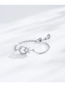 Macro detail of S925 silver chain ring featuring moon and star motifs with cubic zirconia