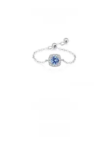 Detail of silver chain ring with a square blue zircon and pavé setting accents