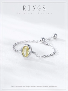 Detail of adjustable S925 sterling silver chain ring with oval yellow zircon setting