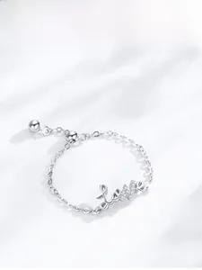 Macro view of S925 silver Love chain ring featuring shimmering pavé cubic zirconia
