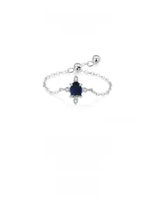 Macro shot of 925 silver chain ring with oval blue gemstone and adjustable slider