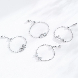 Set of four S925 sterling silver chain rings with celestial stars, moon and Love charms