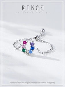 Macro detail of S925 silver chain ring with colorful zircon horseshoe charm and adjustable slide clasp
