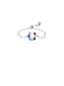 Macro shot of S925 silver horseshoe ring detail with colorful pavé cubic zirconia