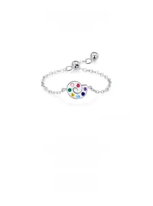 Macro detail of silver palette ring featuring seven colorful cubic zirconia gemstones