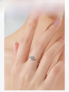 Close-up of a sterling silver snail palette chain ring with colorful zircon on model finger