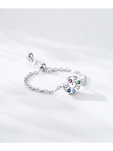 Macro detail of adjustable silver snail chain ring with colorful zircon rainbow stones