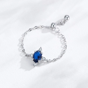 Adjustable S925 sterling silver ring with oval blue gemstone and chain strap
