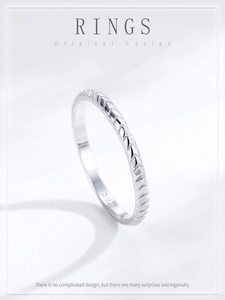 Macro shot of S925 sterling silver ring showing arrow texture and hallmark stamp