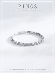 Macro shot of S925 sterling silver ring showing detailed twisted rope texture and minimalist finish