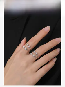 Three stacked 925 sterling silver rings with cubic zirconia on fingers