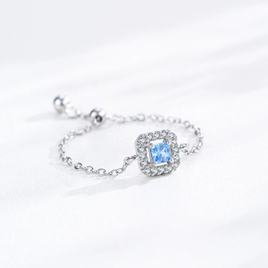 S925 sterling silver chain ring with a square blue zircon and halo setting on white background