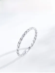 Macro detail of S925 sterling silver rope twist ring with intricate braided texture
