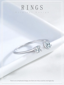 Detail of S925 sterling silver open ring with round and pear-cut cubic zirconia settings