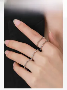 Detailed view of layered S925 sterling silver chain rings with sparkling zircon accents