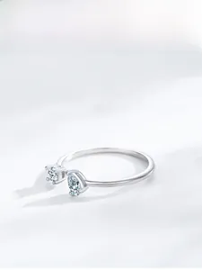 Macro shot of S925 sterling silver open ring with round and pear-cut zircon stones