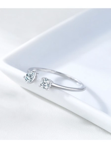 Close-up of S925 silver ring featuring pear and round cut zircons on a white ceramic edge