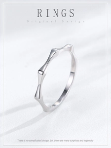 Macro shot of minimalist S925 sterling silver bamboo ring with polished wavy contours